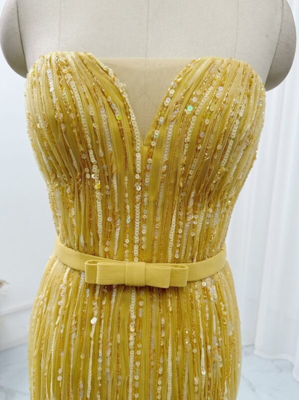 Sweetheart corset bodice detail on golden yellow sequin prom dress