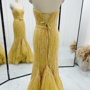 Back detail of golden yellow corset sequin mermaid prom dress