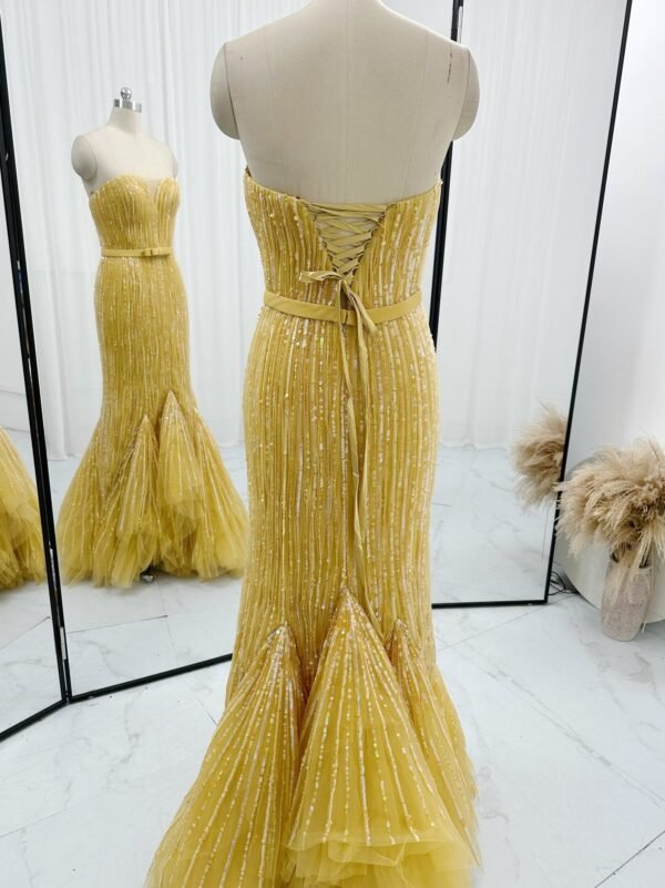 Back detail of golden yellow corset sequin mermaid prom dress