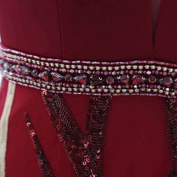 Jeweled waistband detail on burgundy evening gown