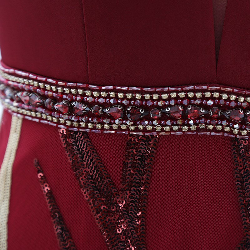 Jeweled waistband detail on burgundy evening gown