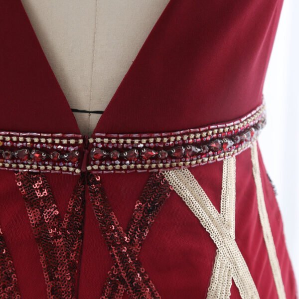 Low V-back and jeweled waist detail of burgundy gown